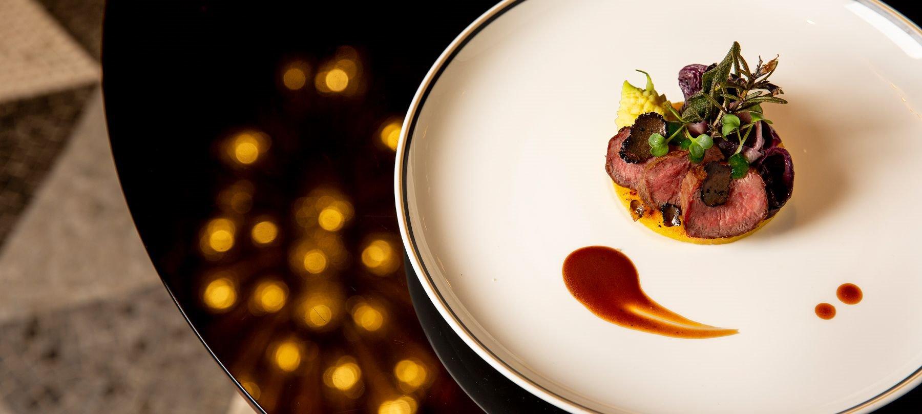 A plated beef tenderloin finished with truffle.